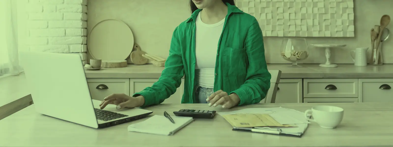 Mujer revisando su presupuesto y sus cuentas con una calculadora en la mesa de la cocina